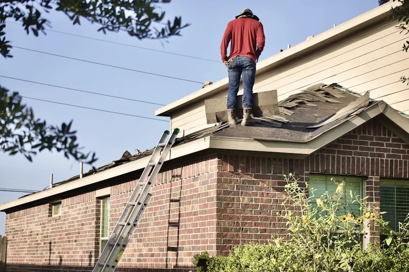 Professional roofer working on a residential roof in New Salem